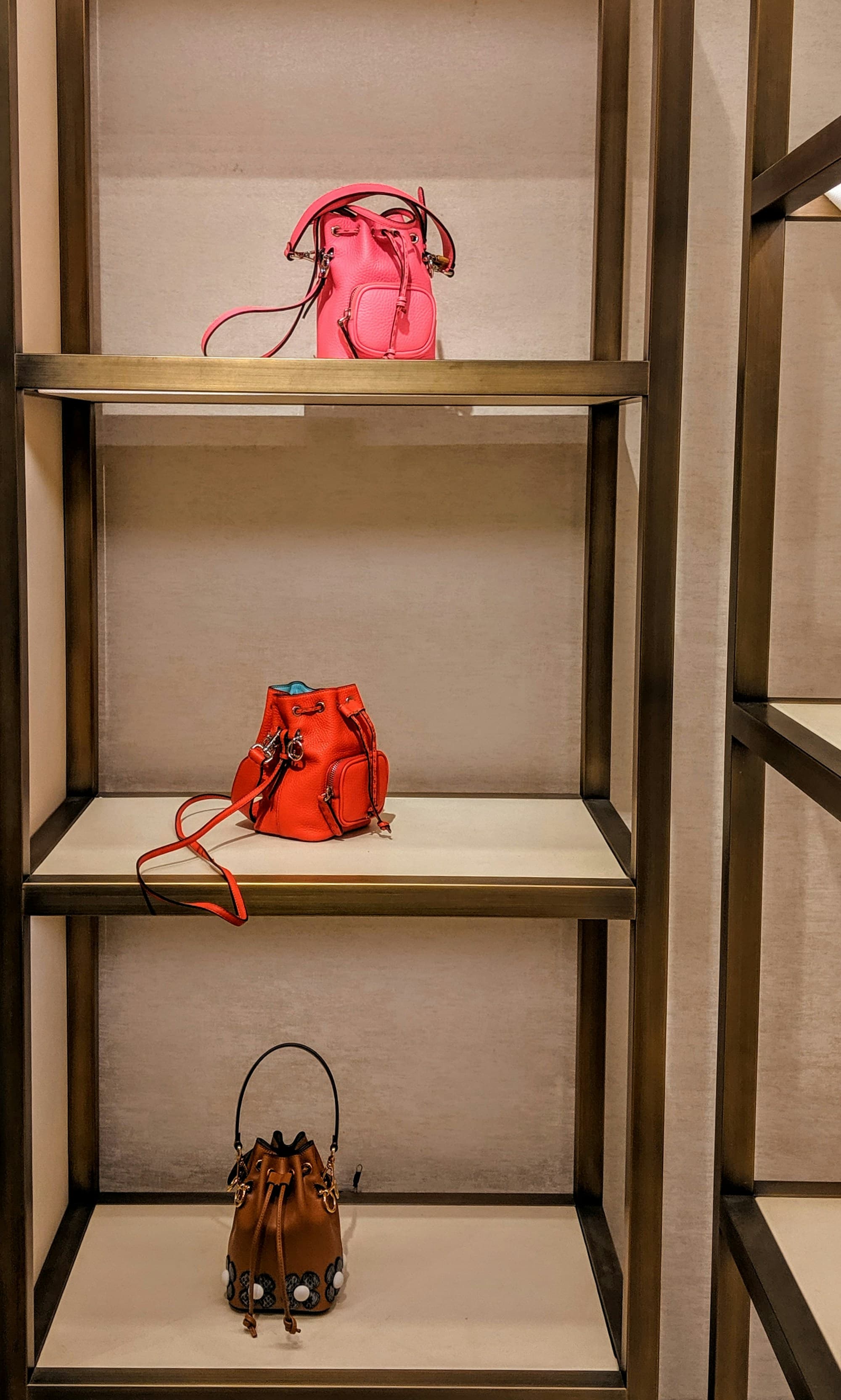Leather bucket bags displayed on shop shelves